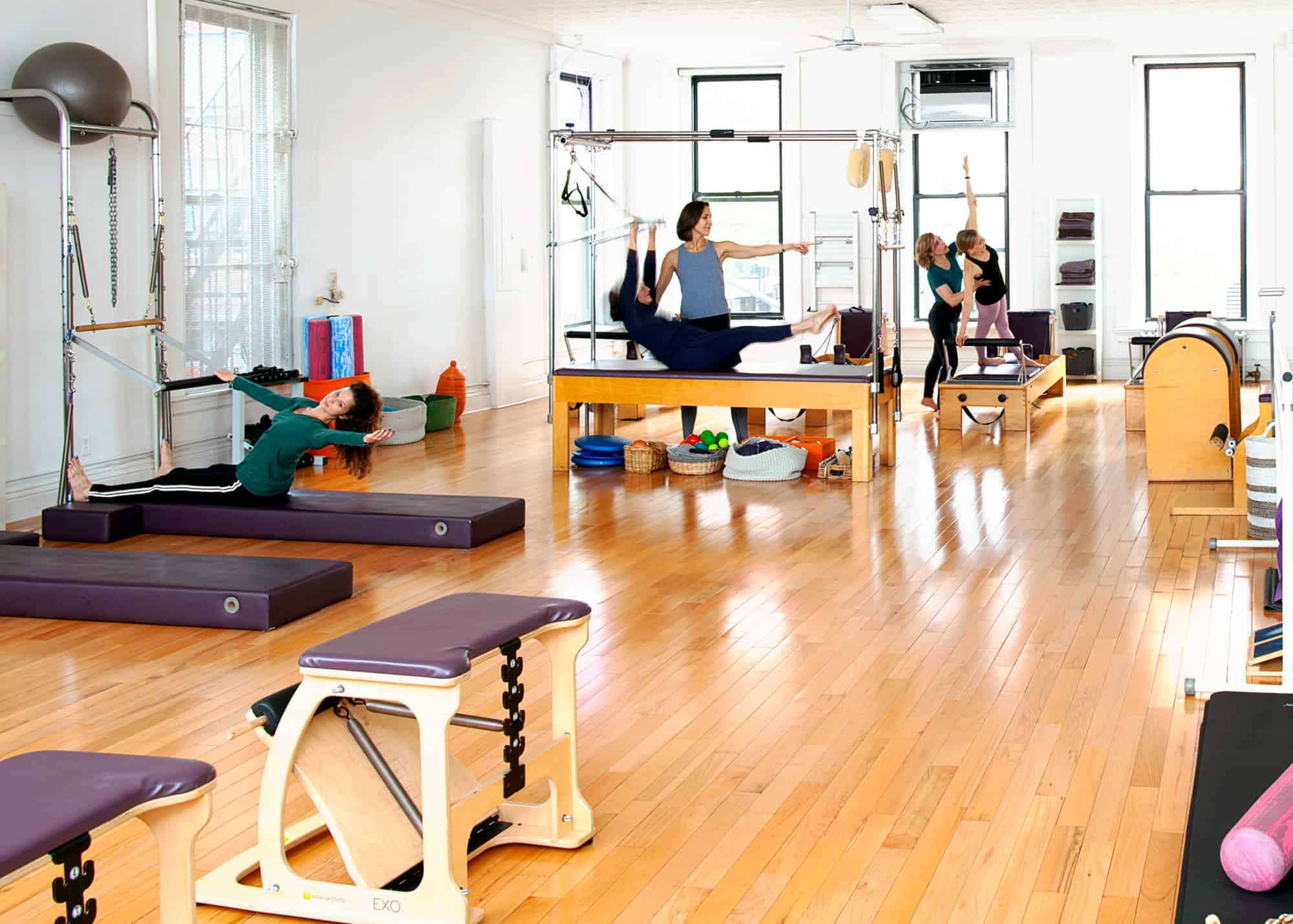 Pilates studio in Brooklyn, NY. People performing exercises.