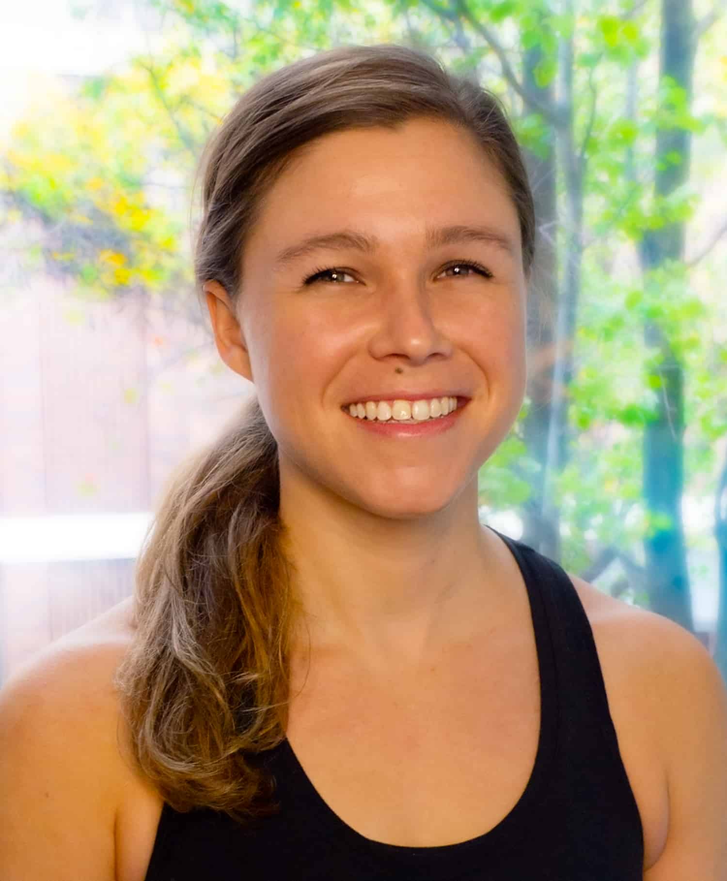 Portrait of Pilates Instructor Stefanie Doolittle in front of a window at Streamline Pilates